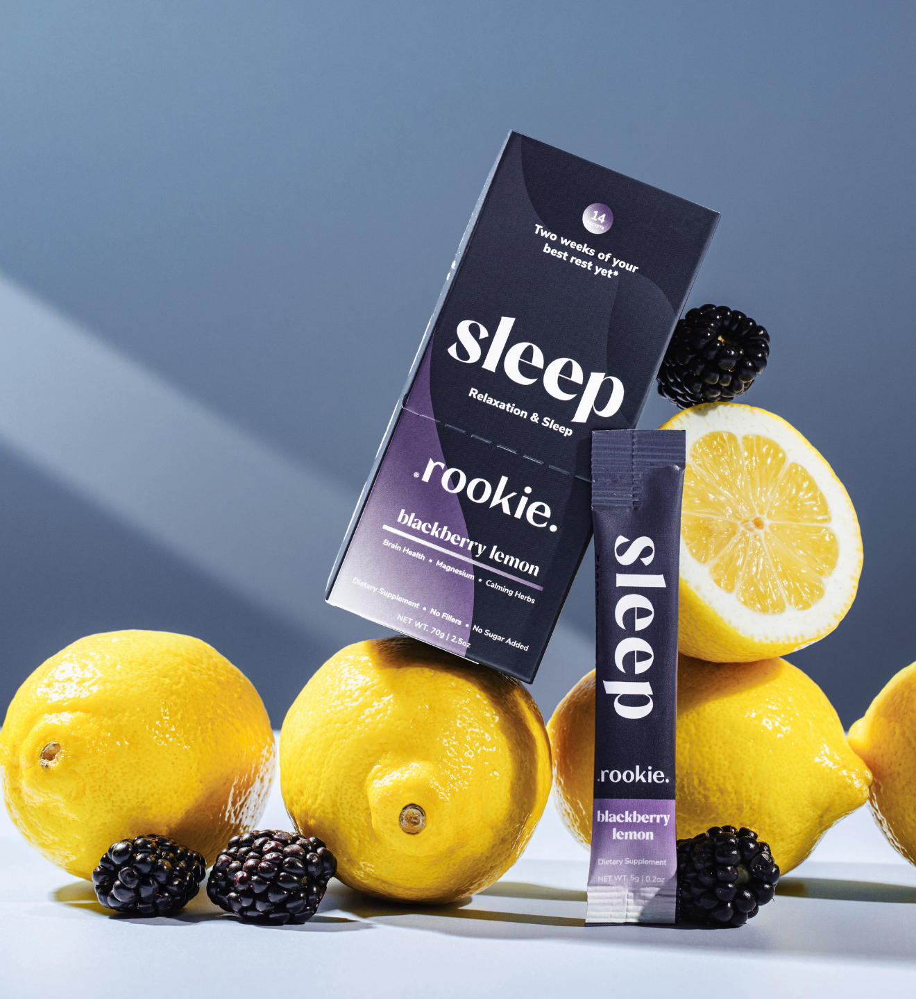 Sleep supplement packaging with lemons and blackberries on a blue background