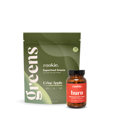 Two products by rookie: a package of superfood greens and a bottle labeled 'burn' on a white background.