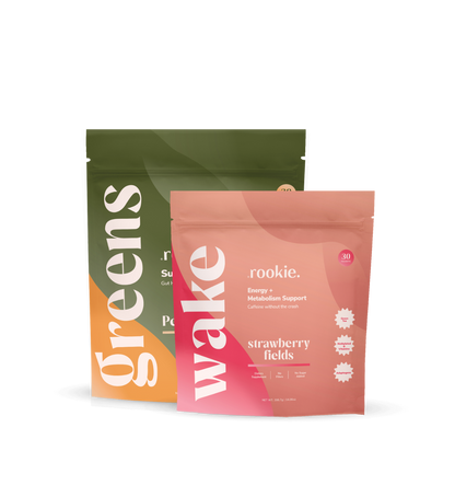 Two supplement packages labeled 'greens' and 'wake' on a white background